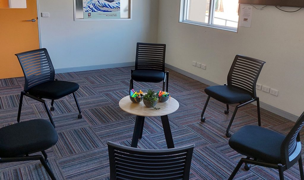 Empty room with six chairs around a small table