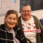 Two older women smiling at camera