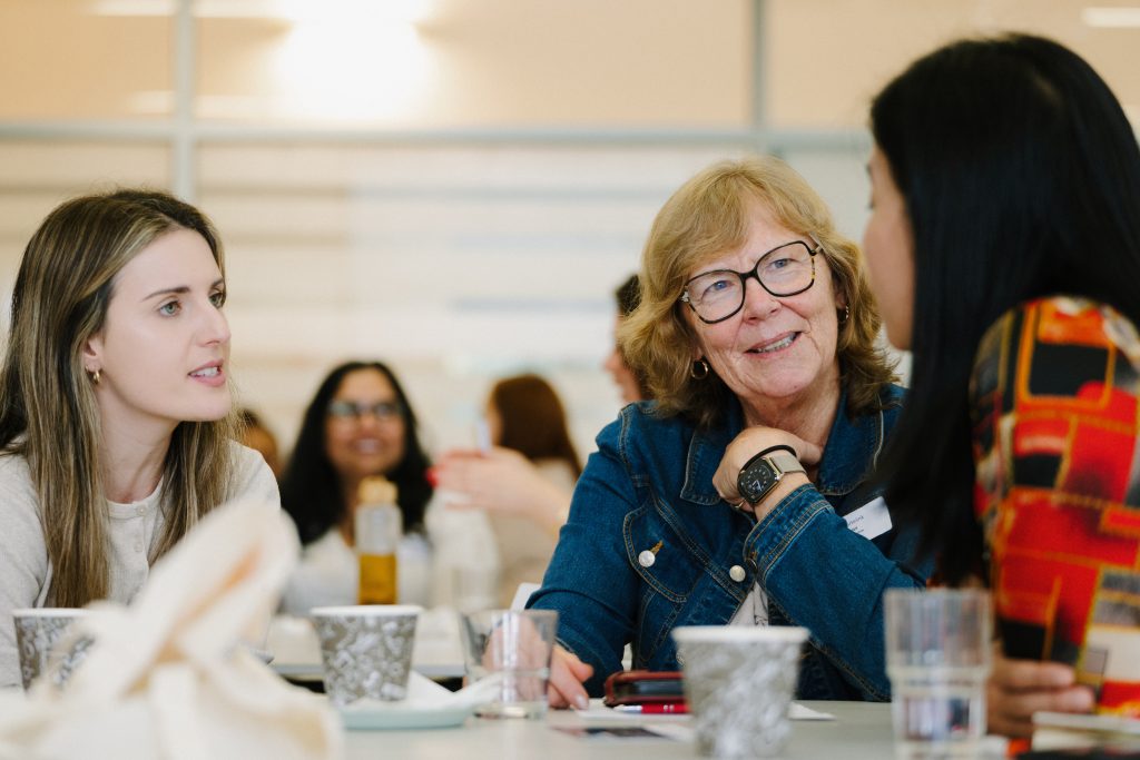 Three women discussing at a table